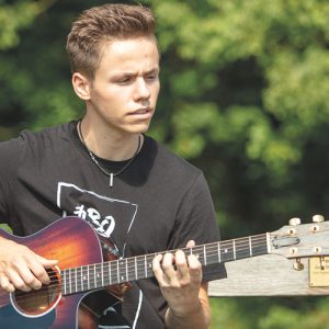 Jungen Mann spielt akustische Gitarre